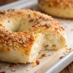 Macro image of golden brown cottage cheese bagel crust with sesame