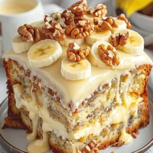 Heavenly Banana Walnut Cream Cake 3 A close up square slice of homemade banana walnut cake with cream cheese filling, dripping caramel glaze, banana slices, and whole walnuts.