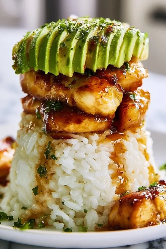 Delicious Chicken Avocado Rice Stack topped with fresh ingredients.