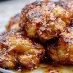 Crispy chicken thighs served on a plate with herbs and spices