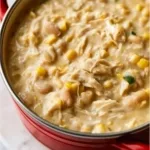 Bowl of homemade white chicken chili topped with cilantro and jalapenos.