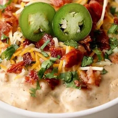 Delicious bowl of Jalapeno Popper Chicken Chili topped with cheese and jalapenos