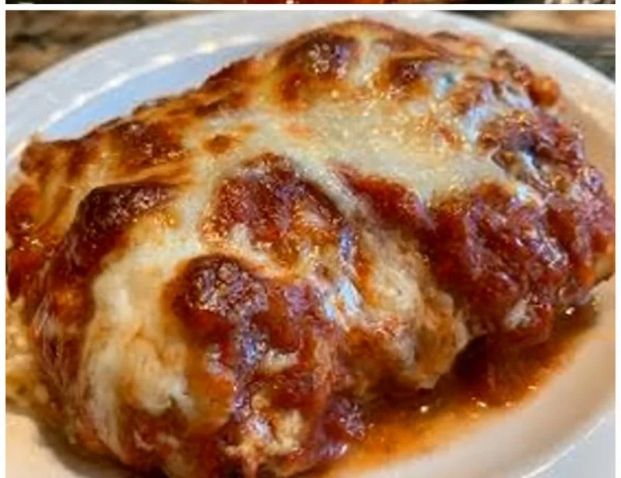 Light Parmesan Chicken dish garnished with herbs on a plate