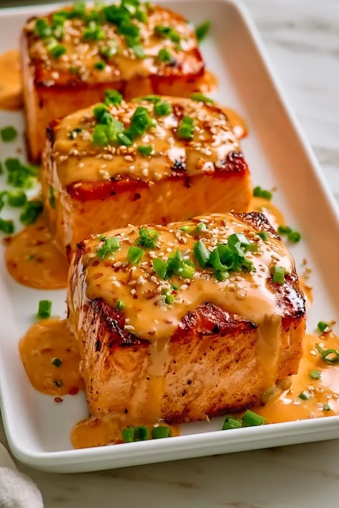Bang Bang Salmon Recipe with spicy sauce and garnishes